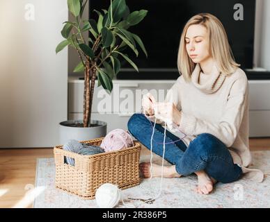 Giovane donna calda maglia Sciarpa a casa Foto Stock