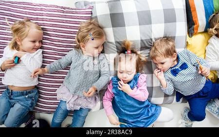 I bambini si trovano sui cuscini Foto Stock