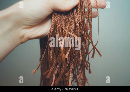 Materiali sintetici per la tessitura, intrecciatura trecce africane zizi, Kanekalon Foto Stock