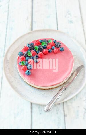 Torta di bacche vegane crude con datteri, anacardi e cioccolato bianco Foto Stock