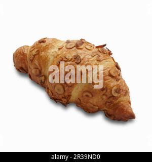 Un croissant a base di noci su una superficie bianca Foto Stock