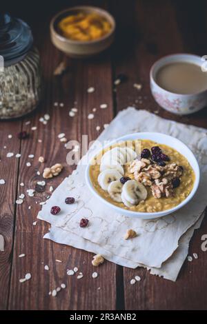 Porridge di zucca con banane, mirtilli rossi secchi e noci Foto Stock