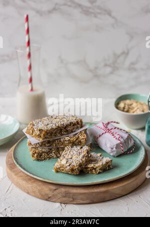 Muesli fatti in casa da noci e frutta secca con avena, latte in un bicchiere Foto Stock