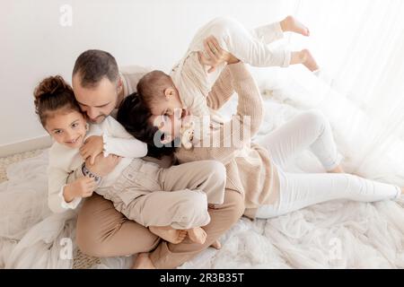 Una famiglia allegra trascorre del tempo libero seduto al piano Foto Stock