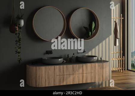 Bagno moderno con pavimento in parquet marrone scuro, due lavandini neri, doppi specchi, piante interne, pareti scure. Bagno minimalista e moderno Foto Stock