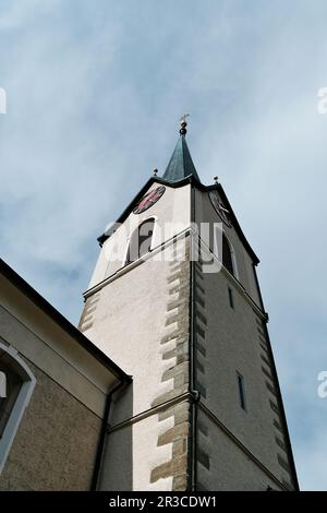 Una struttura torreggiante in cima ad una chiesa, spesso adornata con dettagli architettonici e una campana, che serve come un punto di riferimento prominente in una comunità. Foto Stock