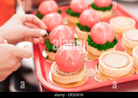 Il pasticcere decora un bel dessert di mousse francese Foto Stock