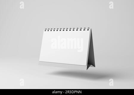 Calendario desktop bianco mensile fluttuante in ombra di lancio a mezz'aria su sfondo bianco in scala di grigi monocromatico. Orari e appuntamenti di lavoro Foto Stock