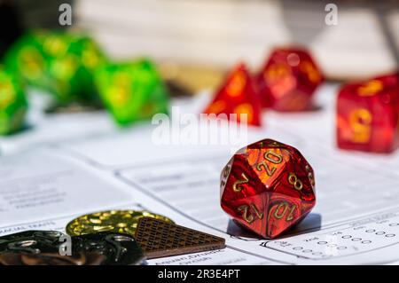 Una macro immagine di un gioco di ruolo rosso morire su un foglio di un personaggio Foto Stock