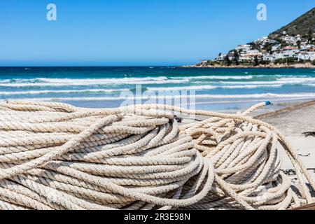 Tradizionale rete da pesca su piccola barca a remi in spiaggia Foto Stock