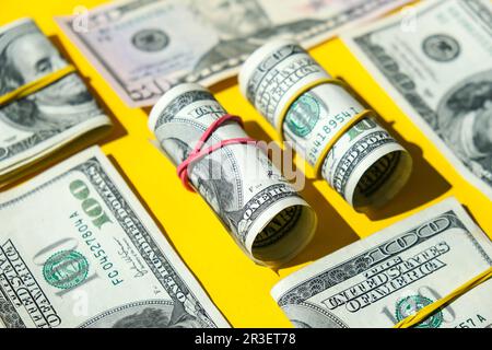 DOLLARI USA bundle primo piano isolato su sfondo dollaro. Tagli di carta di dollari in rotoli con fasce di gomma. Business Foto Stock