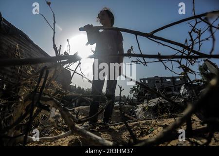 Gaza, Palestina. 23rd maggio, 2023. Una ragazza palestinese si trova accanto alle macerie della casa della famiglia Abu Taha, che è stata distrutta a seguito di uno sciopero aereo israeliano su Beit Lahiya, nella parte settentrionale della striscia di Gaza. Israele e la Jihad islamica hanno accettato una tregua cagionata dall'Egitto alla fine del 13 maggio. Israele ha sferrato diversi attacchi contro la leadership militare del movimento palestinese della Jihad islamica, in rappresaglia al lancio di razzi contro Israele dalla striscia di Gaza. Credit: SOPA Images Limited/Alamy Live News Foto Stock