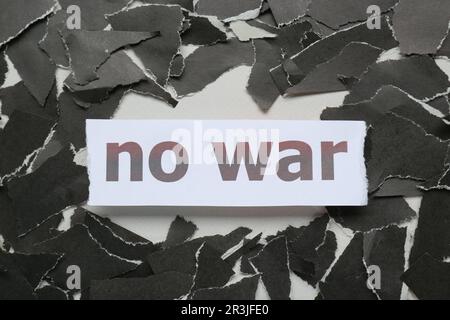 Parole Nessuna guerra e pezzi di carta nera strappata su sfondo bianco, piatto Foto Stock