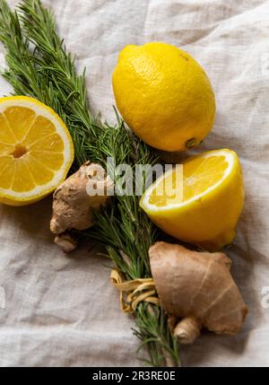 Mazzetto di zenzero e limone al rosmarino fresco su un panno di lino naturale Foto Stock