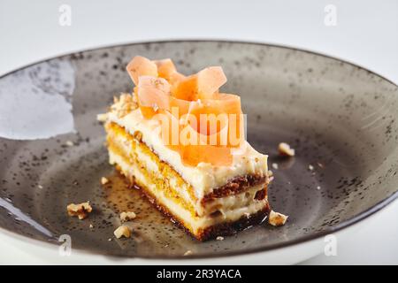 Fetta di torta di carote in primo piano su sfondo bianco Foto Stock