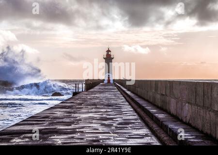 Faro maestoso su un molo che si affaccia sul mare. Farolim de Felgueiras, Porto, Portogallo Foto Stock