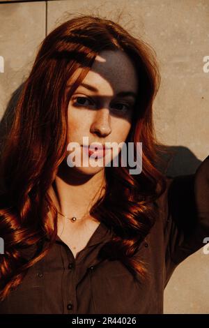 Ginger Girl con Freckles al tramonto vicino a Old Architecture Foto Stock