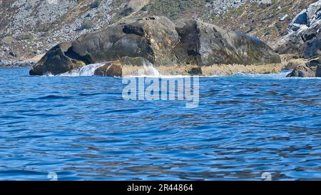 norvegia sul fiordo, spruzzare sulle rocce. Spruzzi d'acqua sulle pietre. Paesaggio costiero in Scandinavia. Foto del paesaggio da nord Foto Stock