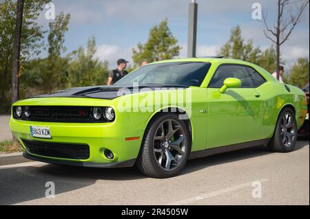 Vista frontale di una bella macchina muscolosa americana Dodge Challenger RT hemi in colore verde calce e cofano nero Foto Stock