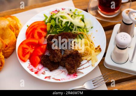 Kofte turco alla griglia di agnello con contorno di verdure Foto Stock