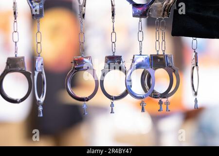 Diversi manette in acciaio sospeso con un piccolo tasto su uno sfondo sfocato. Scatto medio Foto Stock