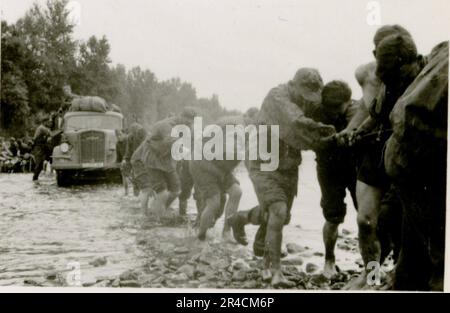 SS fotografo Willi Altstadt, Wiking Division, Russia 1942. Scene del villaggio della zona di Rostov, un Panzer III (con simboli unitari) e granatieri panzer sulla steppa, scene di combattimento lungo un fiume, primi piani della fanteria sul campo con armi individuali e servite dall'equipaggio, attraversamento del fiume (zattere d'assalto e pontone), costruzione di un blocco stradale, prigionieri di guerra russi, I soldati delle SS pescano e nuotano, cerimonia di premiazione delle unità, posto di osservazione affacciato su un fiume e equipaggio di artiglieria pesante con howitzer. Immagini che illustrano le attività in prima linea delle unità Waffen-SS sul fronte occidentale e orientale, i Foto Stock