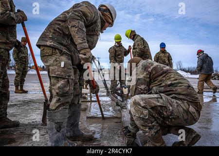 Gli airmen con il livello 114th di Squadron dell'ingegnere civile una patch da un'operazione rapida di riparazione della pista durante l'esercitazione di Lobo Trident a Hector Field, North Dakota 31 marzo 2023. Hector Field è stato creato come una stazione operativa in avanti simulata in un paese amichevole per dare ad Airmen la possibilità di praticare operazioni di emergenza in tempo di guerra e comunicazioni in una posizione remota. Foto Stock