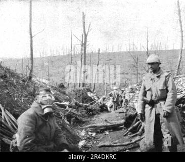 ''le Champ de Bataille; Nos soldats s'ament: un fantasin s'est applique un masque a gaz allemand "a groin de porc" , trouve sur le Terrain', 1916. From "l'Album de la Guerre 1914-1919, Volume i" [l'Illustration, Paris, 1924]. Foto Stock