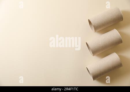 Rotoli di carta igienica vuoti su fondo beige piatto. Spazio per il testo Foto Stock