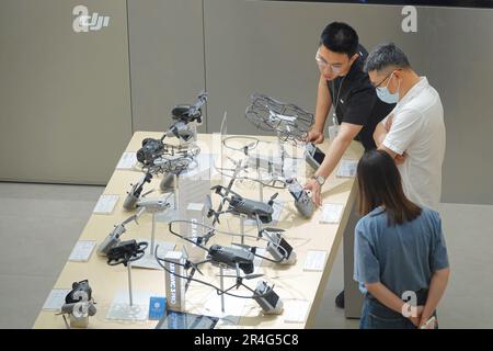 YANTAI, CINA - 27 MAGGIO 2023 - un dipendente di un negozio DJI EXPERIENCE espone un drone DJI a Yantai, provincia di Shandong nella Cina orientale, 27 maggio 2023. Foto Stock