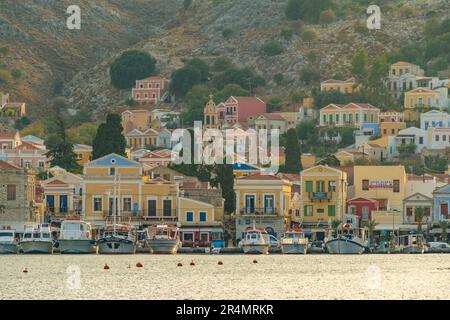 Vista degli edifici colorati che allineano il porto di Symi Town, Symi Island, Dodecaneso, Isole greche, Grecia, Europa Foto Stock