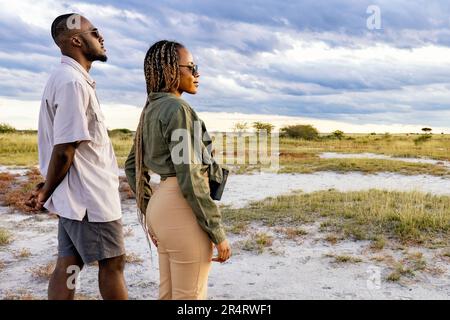 Coppia godendo uno stile di vita sundowner in Onguma Game Reserve, Namibia, Africa Foto Stock