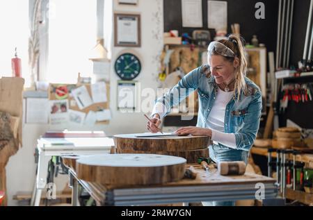 Artigianato che lavora con il legno in Falegnameria officina Foto Stock