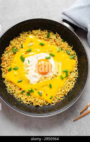 Kujirai Ramen, Shin Ramyeon o Ramyun con uova, formaggio fuso e scalogno, noodle istantanei su sfondo luminoso Foto Stock