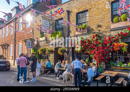 La scena è molto trafficata fuori dal pub Two Brewers a Windsor, Berkshire, Regno Unito, con persone nella birreria all'aperto che bevono birra e un Union jack bunting che decorano la strada. Foto Stock