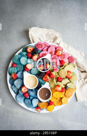 Mini muesli colorati con frittelle e frutti di bosco Foto Stock