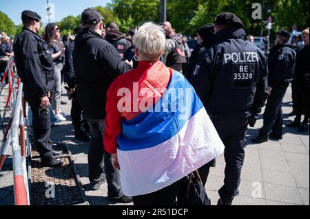 09.05.2023, Berlino, Germania, Europa - Un sostenitore pro-russo con una bandiera nazionale russa il giorno della Vittoria di fronte al Memoriale di guerra sovietico. Foto Stock