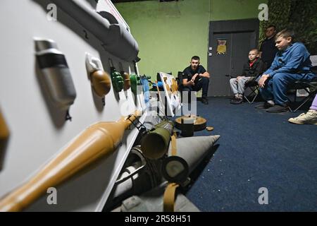 ZAPORIZHZHZHZHIA, UCRAINA - 01 GIUGNO 2023 - l'ufficiale SES racconta ai bambini i tipi di munizioni durante la Safety quest tenutasi al Vohnyk Zaporizhzhzhzhia NTC, Zaporizhzhzhia, Ucraina sud-orientale. Foto Stock