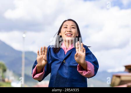 Un artista della Royal Academy of Performing Arts (RAPA) di Thimphu, Bhutan, dimostra graziosamente la danza tradizionale bhutanese. Foto Stock