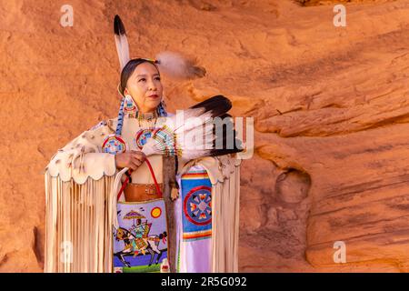 Donna americana indiana Navajo al Honeymoon Arch nella Mystery Valley della Monument Valley Navajo Tribal Park, Arizona, Stati Uniti Foto Stock