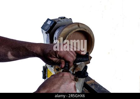 Artigiano che crea una ciotola di legno sul tornio. Immagine in officina. Sfondo bianco. Foto Stock