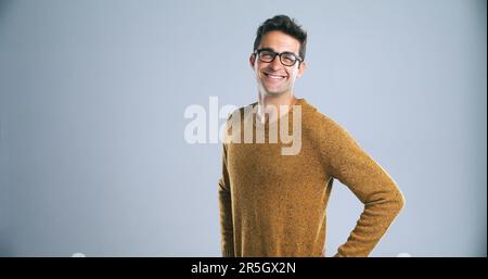 Niente dice la fiducia come una forte immagine di sé. Studio shot di un giovane fiducioso e bello in posa su uno sfondo grigio. Foto Stock