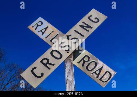 Old Railroad Crossing segno contro il cielo blu Foto Stock