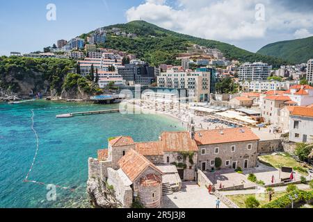 Una piccola spiaggia si trovava dietro gli edifici medievali del centro storico di Budva, sulla costa del Montenegro, visto nel maggio 2023. Foto Stock