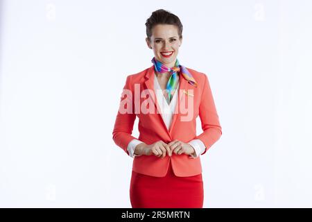 donna moderna sorridente, in uniforme, su sfondo bianco. Foto Stock