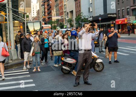 Gli amanti dell'astronomia rischiano la vita e l'arto mentre si trovano in West 23rd Street a Chelsea a New York per fotografare la seconda notte del tramonto di Manhattanhenge martedì 30 maggio 2023. Due volte all'anno, il sole si allinea al tramonto con la griglia della città e si trova al centro delle strade. L'evento, il nome coniato da Neil deGrasse Tyson del Planetario Hayden, si svolge 22 giorni prima e 21 giorni dopo il solstizio estivo a causa dell'angolo di 30 gradi della griglia della città, non è esattamente est-ovest-nord-sud. (© Richard B. Levine Foto Stock