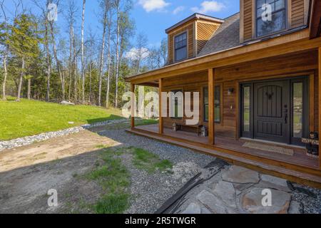 Una moderna casa a due piani con portico e porta che conduce all'entrata frontale Foto Stock