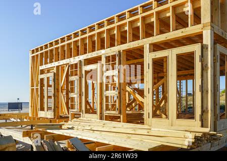 Costruzione di un nuovo edificio in legno naturale sulla costa baltica per una caffetteria stagionale con sfondo blu cielo Foto Stock