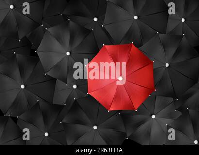 Immagine concettuale con un sacco di ombrelli neri e un ombrello rosso che si distingue, essere unico Foto Stock