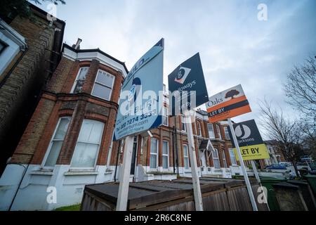 Londra - 1 marzo 2023: Cartelli per agenti immobiliari sulla strada di case residenziali terrazzate al largo di Streatham High Street nella SW16 sud-ovest di Londra Foto Stock
